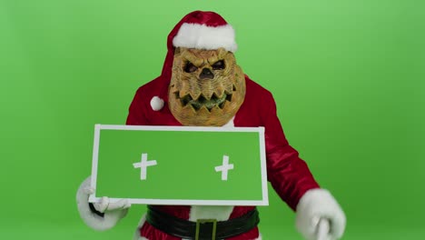 scary santa claus holding blank chalkboard