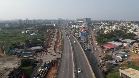 indian highway bridge on cinematic aerial footage with heavy traffic due to accident and the construction of a metro train bridge construction in above the service road