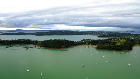 aerial view of a coastal bay with sailboats under a cloudy sky