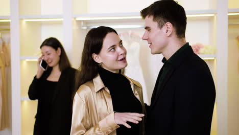 couple talking in a wedding dress shop