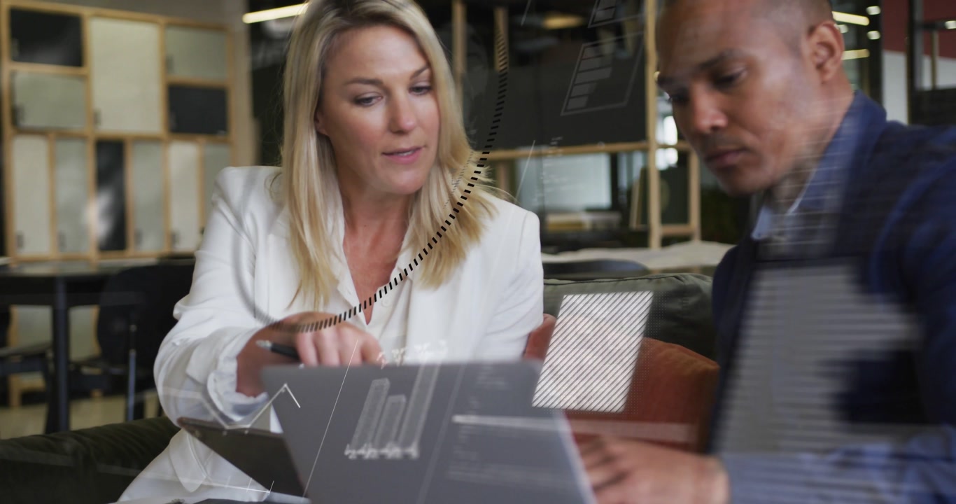 Vertical video: Woman opening tablet man leaning syncing on laptop while tech data flowing on UI