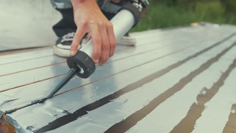 applying sika flex sealant between timber planking wood boat maintenance