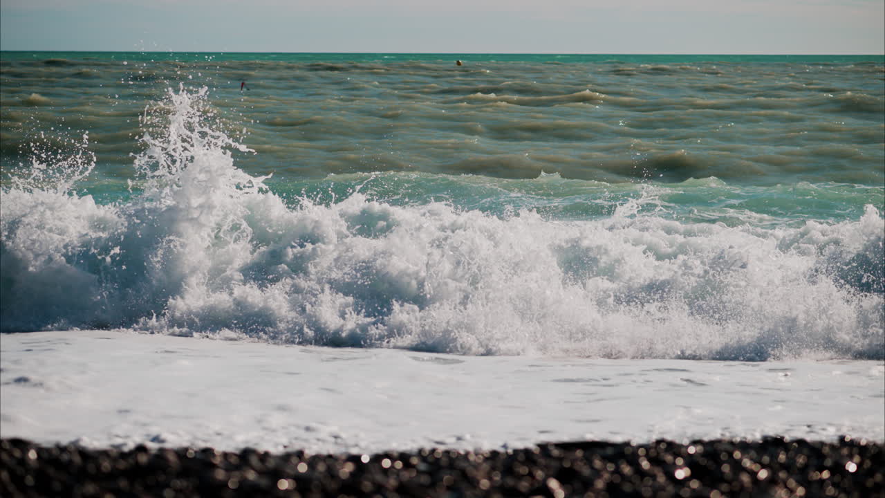 Waves hitting the shore on the beach in Cannes, France