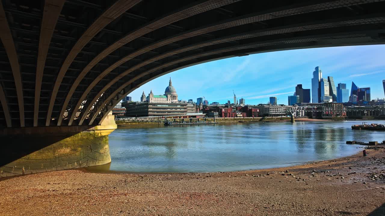 Slow reveal of St Paul's Cathedral from under Blackfriars Bridge in London, England, UK
