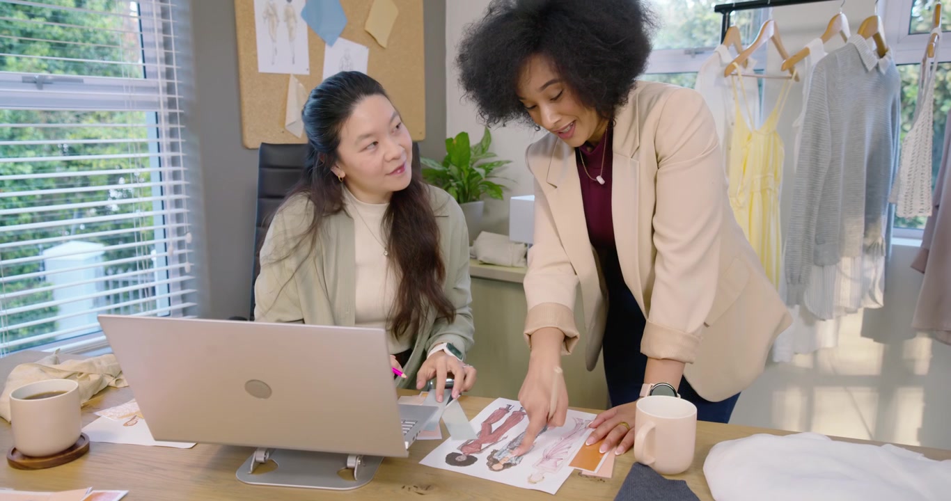 African American Asian women opening swatches, matching to sketches, deciding details in studio