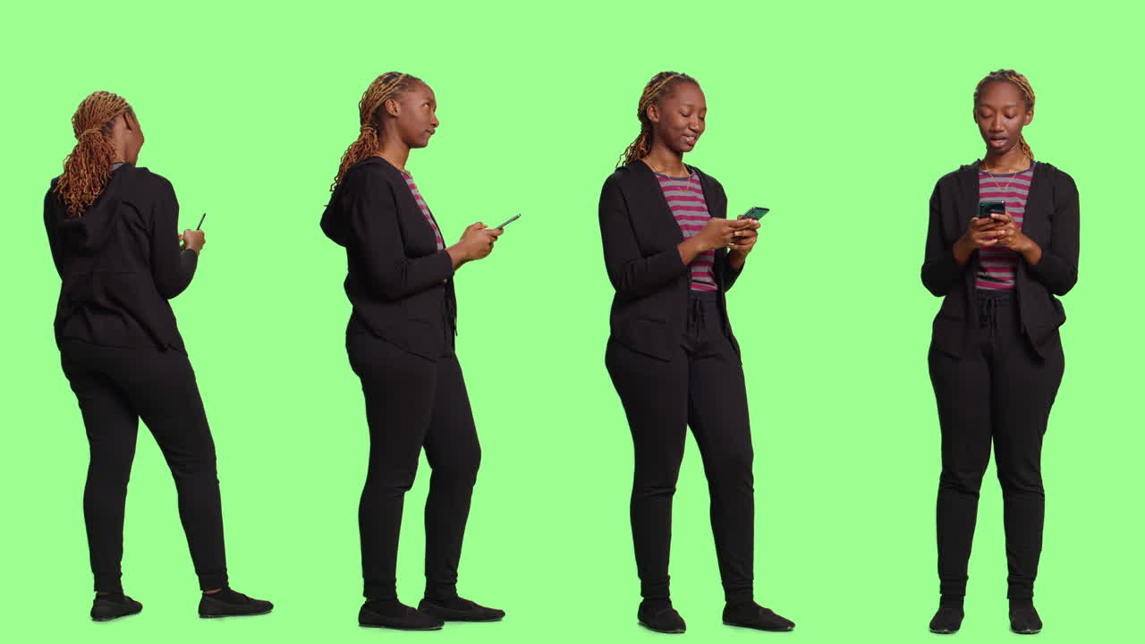 Woman in Casual Clothing Using a Phone in the Studio