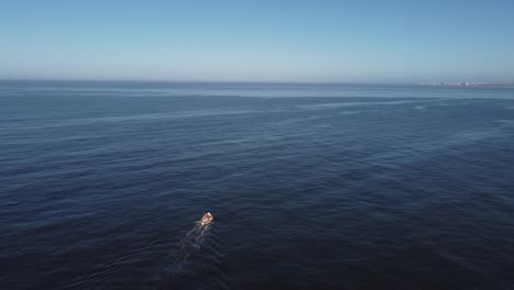 fishing motorboat leaves wake trail on sea water surface