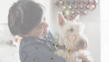 animación de corazones y confeti sobre mujer caucásica con su perro mascota.
