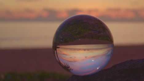 beautiful sunrise above the sea inside crystal ball.