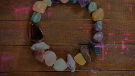 showcasing open gemstone circle forming on wooden tabletop, highlighting polished colorful stones