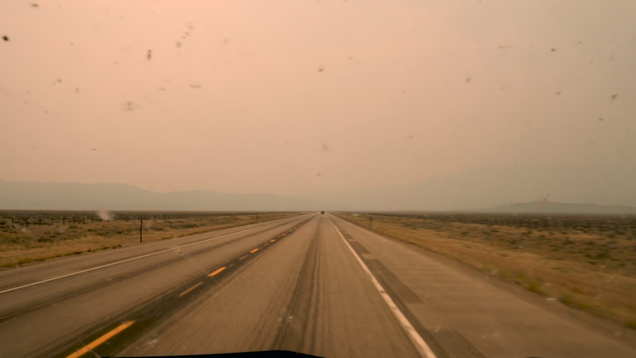 A long take of ash and mist floating in the sky over the west coast of the United States.