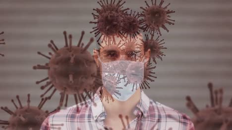Animation-Von-Covid-19-Zellen,-Die-Sich-über-Einen-Mann-Mit-Gesichtsmaske-Bewegen