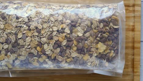 muesli in a plastic bag on a wooden board