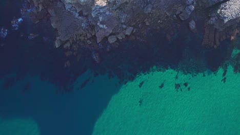 Turquoise-Sea-Water-And-Stones-On-The-Beach-In-Suances,-Spain