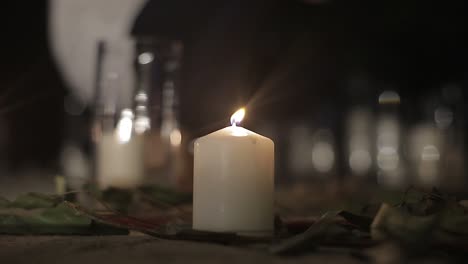Candles-burning-at-night-on-dark-background
