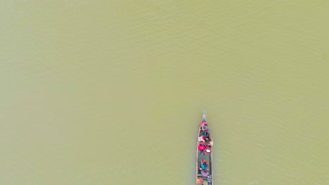 4k aerial top down shot of people in a row boat getting evacuated to land area in majuli river island submerged in the brahmaputra monsoon floods