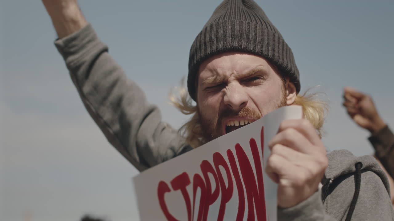 Environmental Activist with Poster Chanting Slogan on Protest