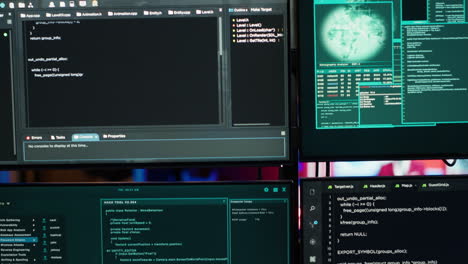 close up of code running on computer displays in empty apartment used by hacker