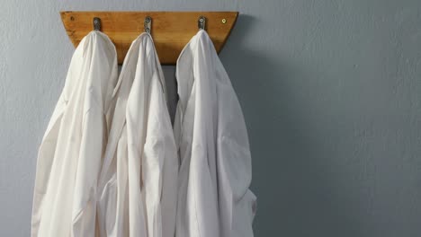 laboratory coats hanging on hook 4k