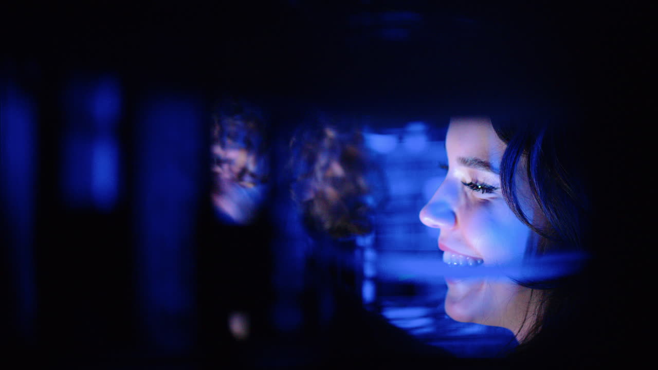 A man and a woman cheering in a server room
