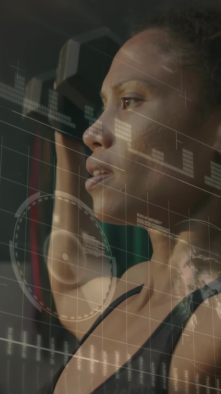 Vertical video: Fit woman holding overhead in gym, HUD charts showing and guiding posture for form