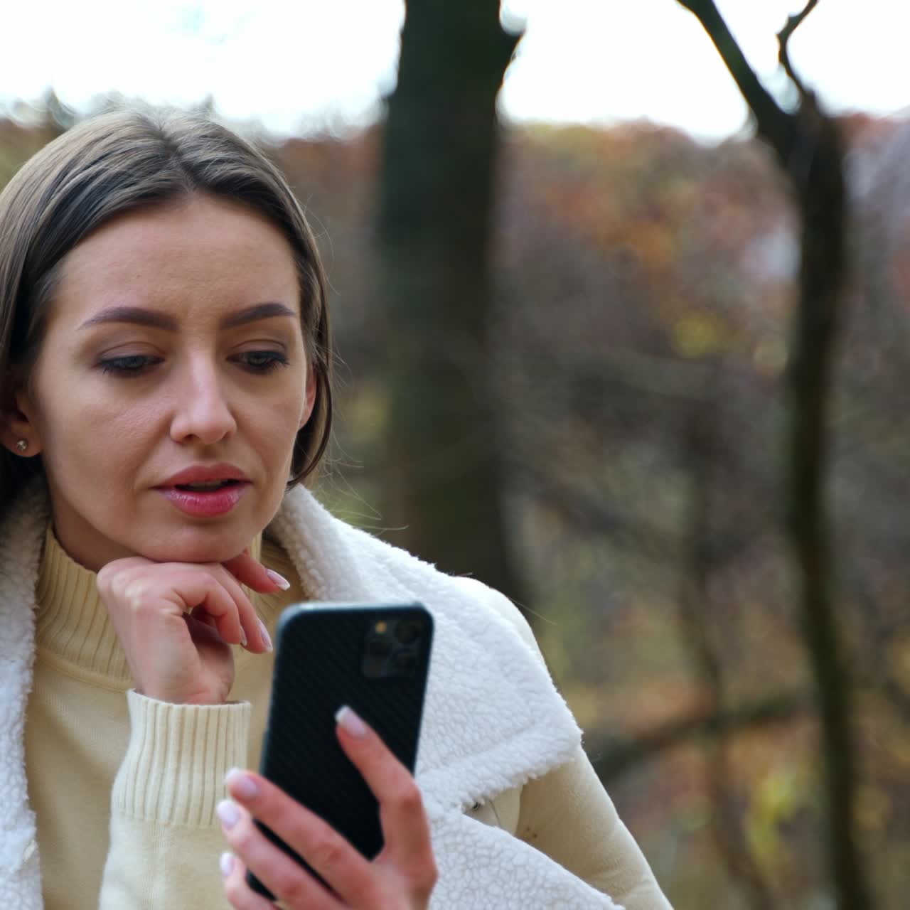 Cheerful woman with autumn background talking on phone. Beauty cute lady portrait having phone call