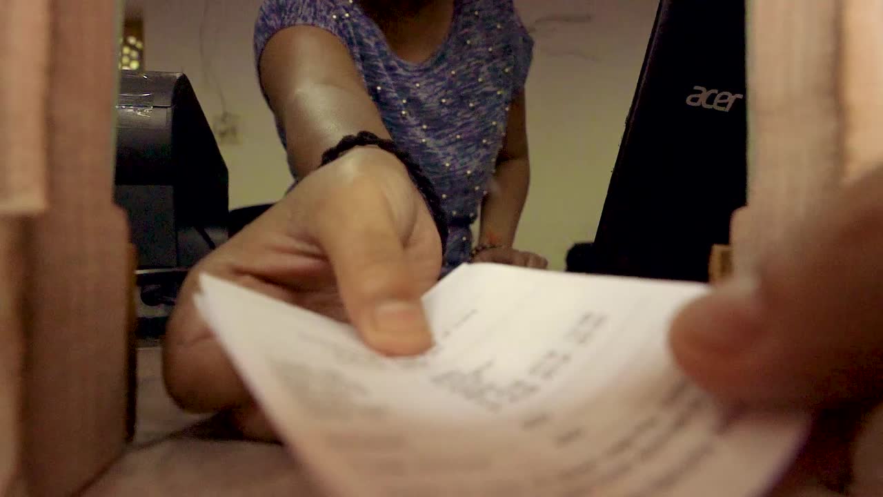 A woman inside a counter selling tickets at Red Fort, New Delhi, India