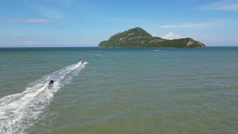 two jet skis speeding towards the island captured in an aerial footage