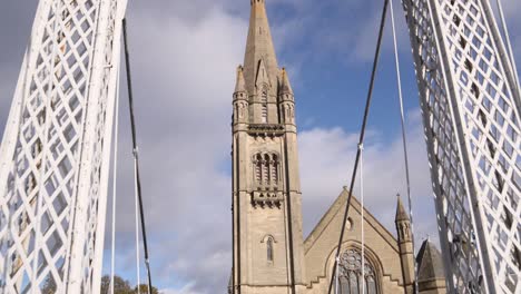 panning-shot-of-old-european-cathedral-through-modern-bridge-in-Inverness,-Scotland-in-the-Highlands