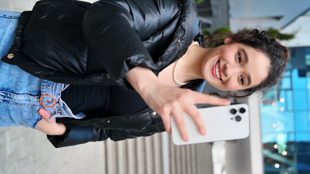 A young woman blogger influencer recording herself on smartphone. Slow motion
