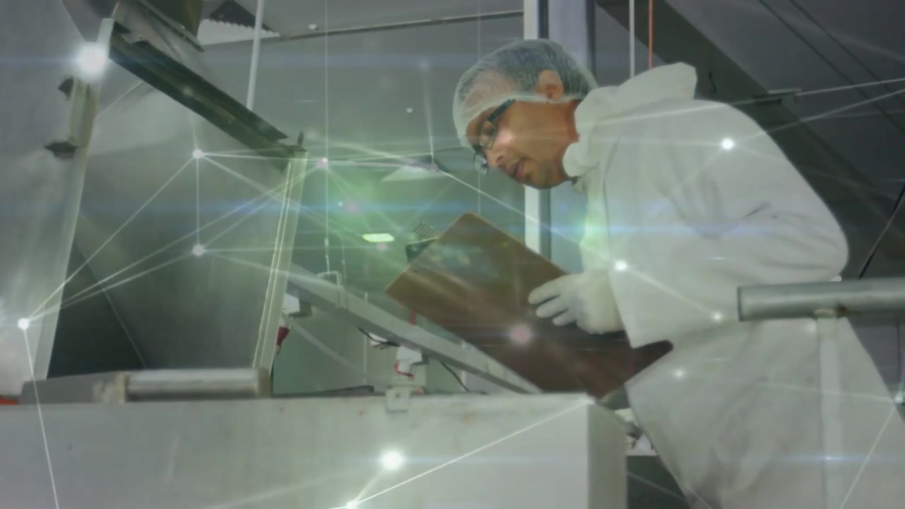 Noticing open hatch, tech inspecting food machine, noting on clipboard for safety nodes overlaying