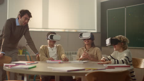 teacher having interactive lesson with students in 3d vr glasses in classroom