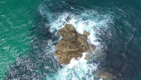 aerial drone view of a rock in the sea in st ives cornwall