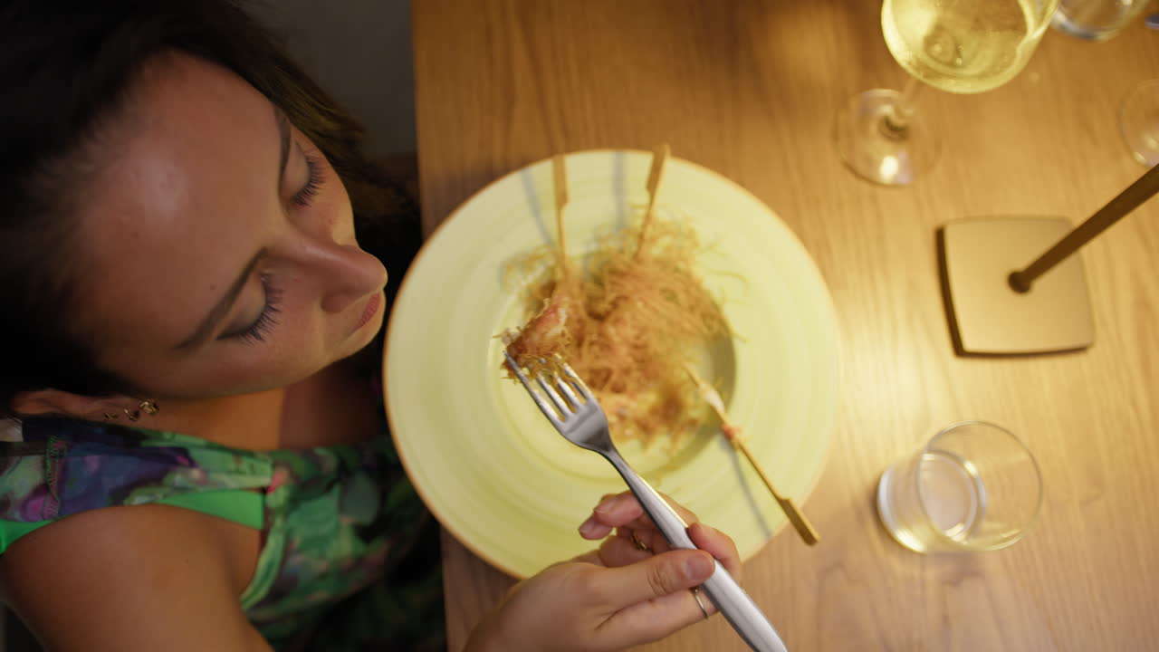 Relaxing And Warm Light Over The Woman Having Dinner At The Restaurant