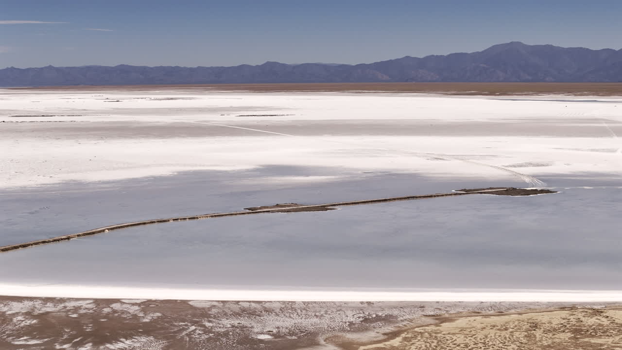 Aerial view of National Route 52 crossing the natural salt flat of Salinas Grandes in Jujuy, Argentina