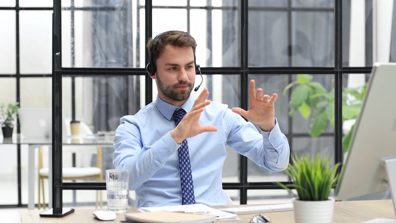 Professional Man in Headset Working and Communicating in Modern Office