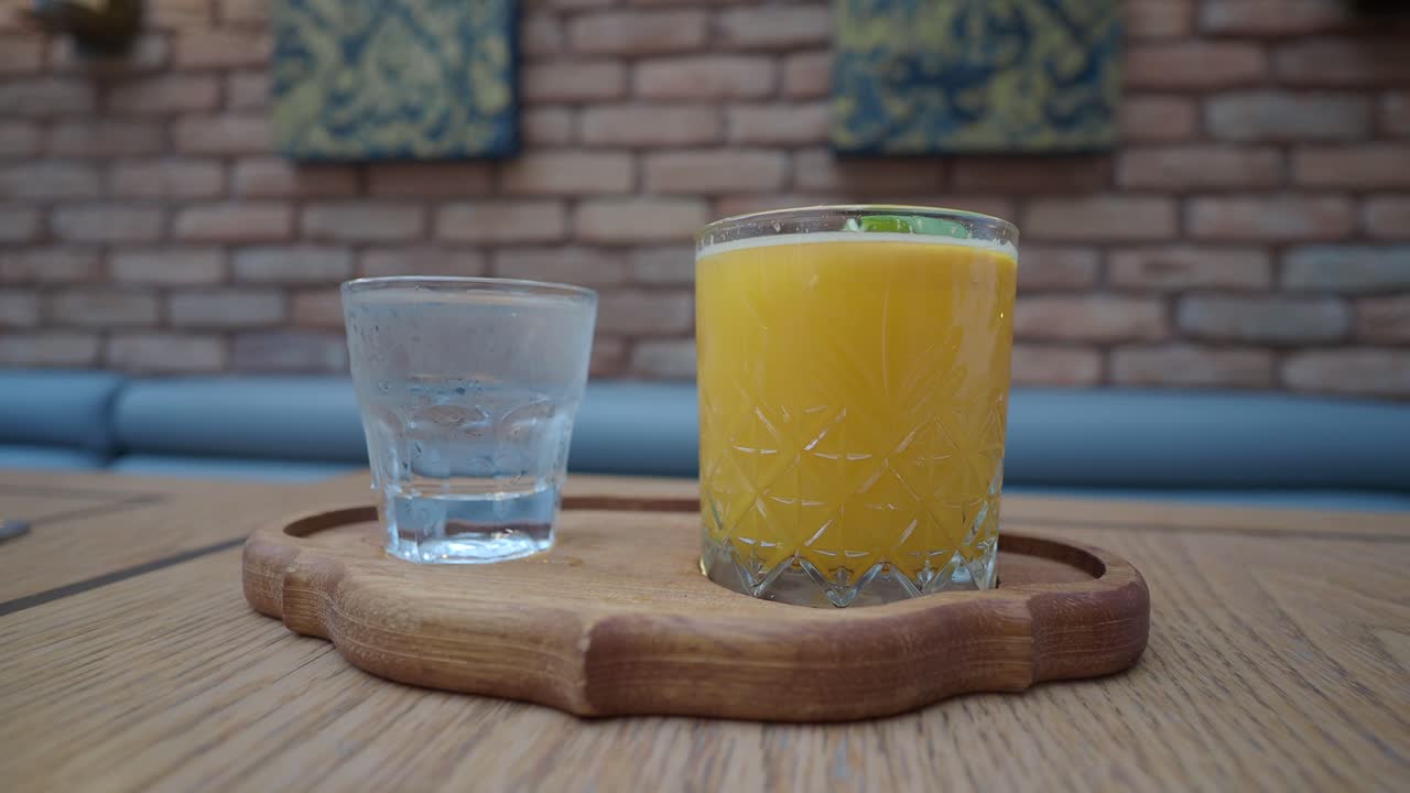 Orange Juice and Water on a Wooden Tray