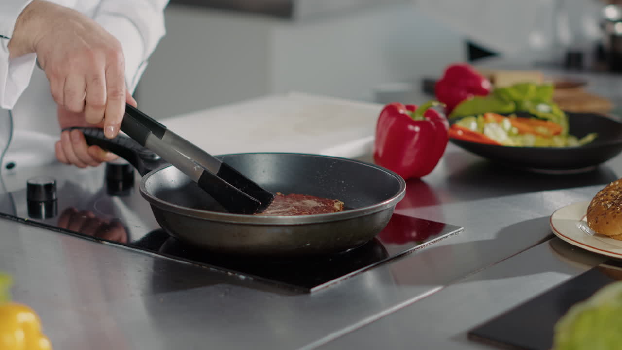 Professional chef cooking pork steak in frying pan on stove