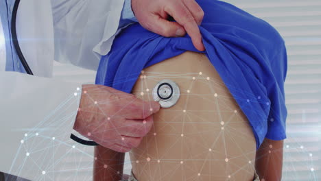 Senior doctor placing stethoscope on boy's back during medical exam with network overlay graphics