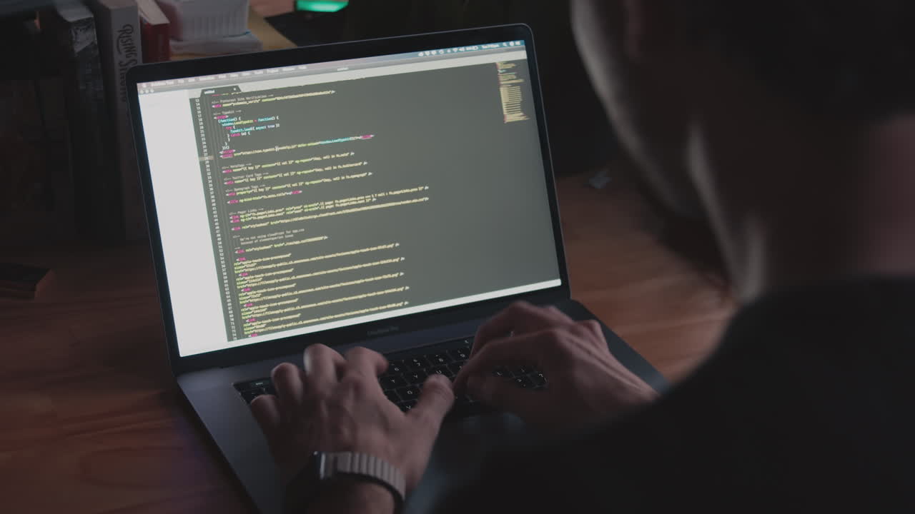 Man types on a laptop