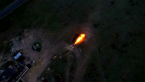 aerial shooting flaring of high-pressure gas from the gas well at sunset.