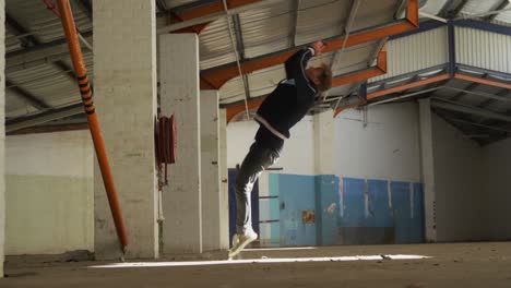 bmx rider in an empty warehouse