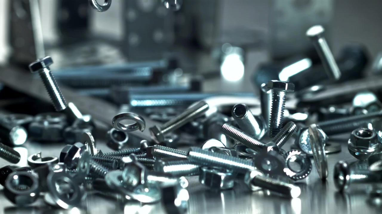 Shiny Metal Fasteners Falling onto a Metallic Surface in Slow Motion