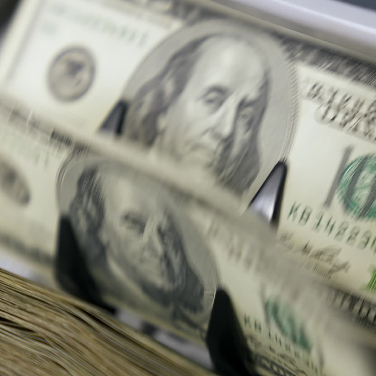 Portrait of President Benjamin Franklin for 100 American dollars cash money. Money counting equipment for paper money calculation. Automatic mechanism for bank financial operations