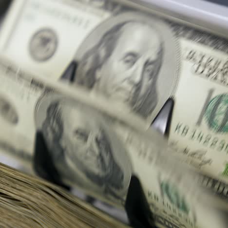 portrait of president benjamin franklin for 100 american dollars cash money. money counting equipment for paper money calculation. automatic mechanism for bank financial operations