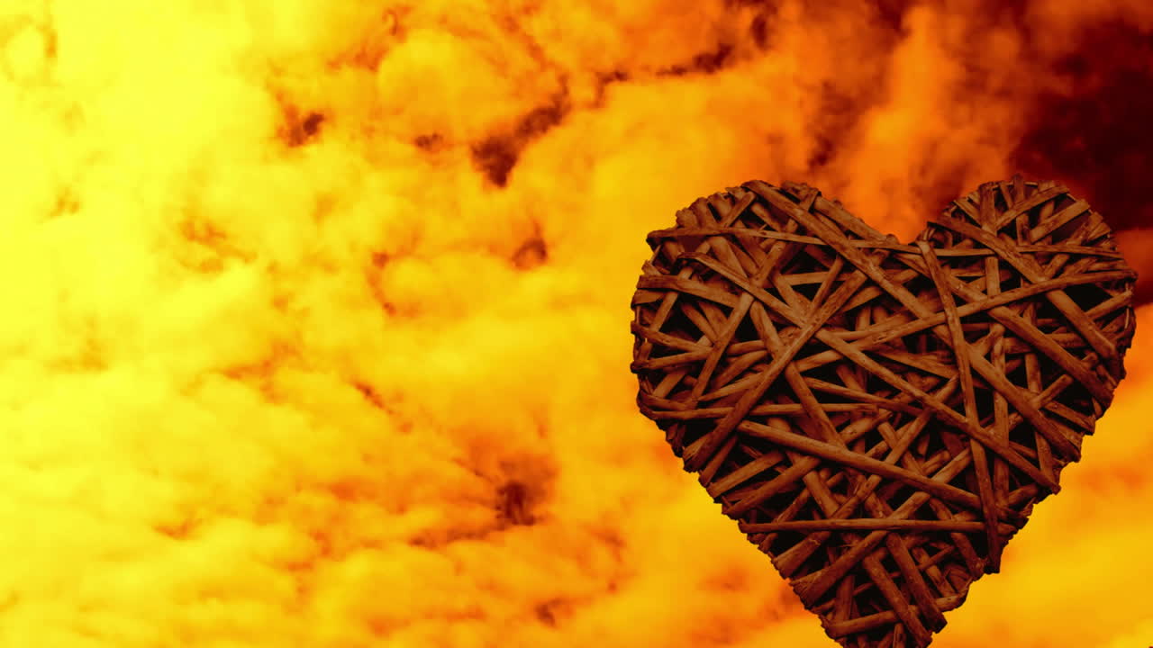 Animación de estructura tejida en forma de corazón con cielo nublado vibrante naranja y amarillo.