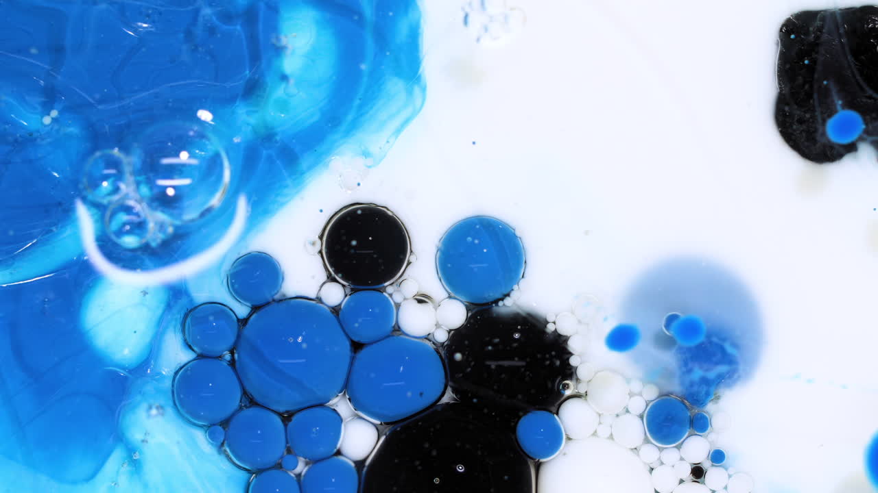 Sfondo artistico astratto di colori blu e neri che vorticano, bolle d'inchiostro che scoppiano e reagiscono