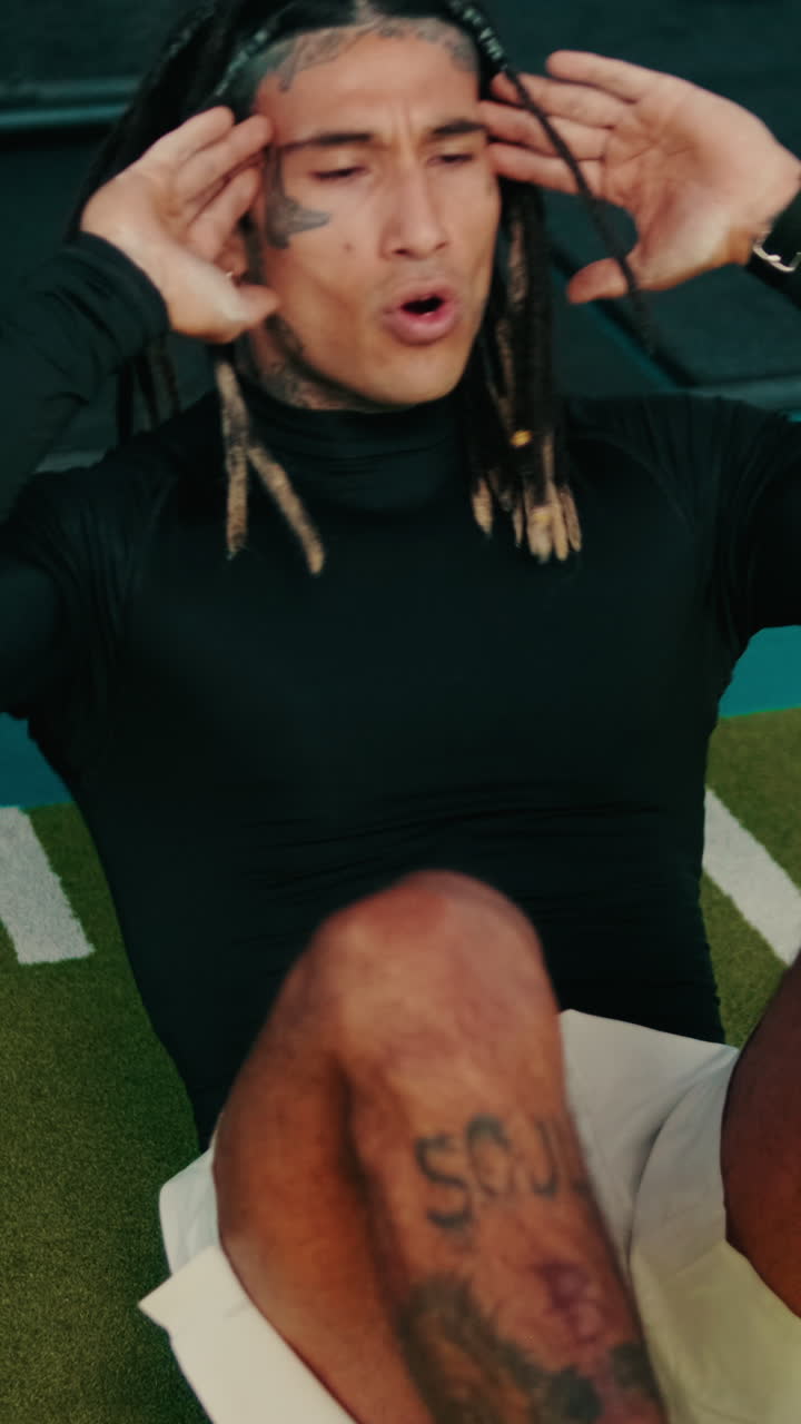 Uomo atletico con dreadlocks che esegue crunch in palestra