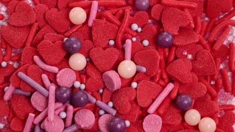 vibrant candy hearts and sprinkles cascade in a dynamic, colorful display. bright lighting enhances the playful, sweet atmosphere