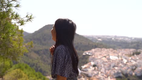 Happy-young-Japanese-girl-laughing-at-camera-on-top-of-mountain